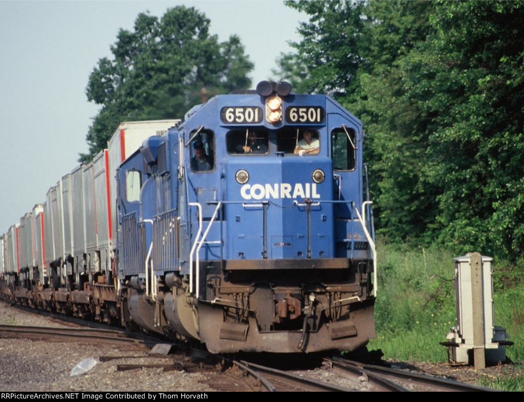 Smiling faces peer out thru the windows as this intermodal approaches Port Reading Jct